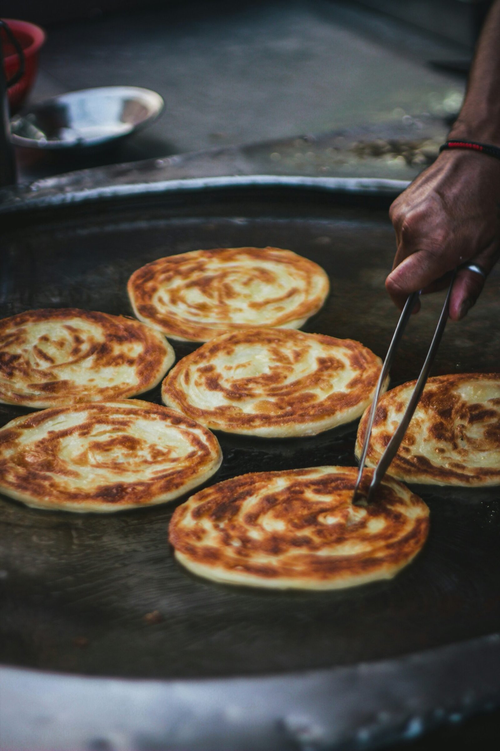 a person slicing a pizza