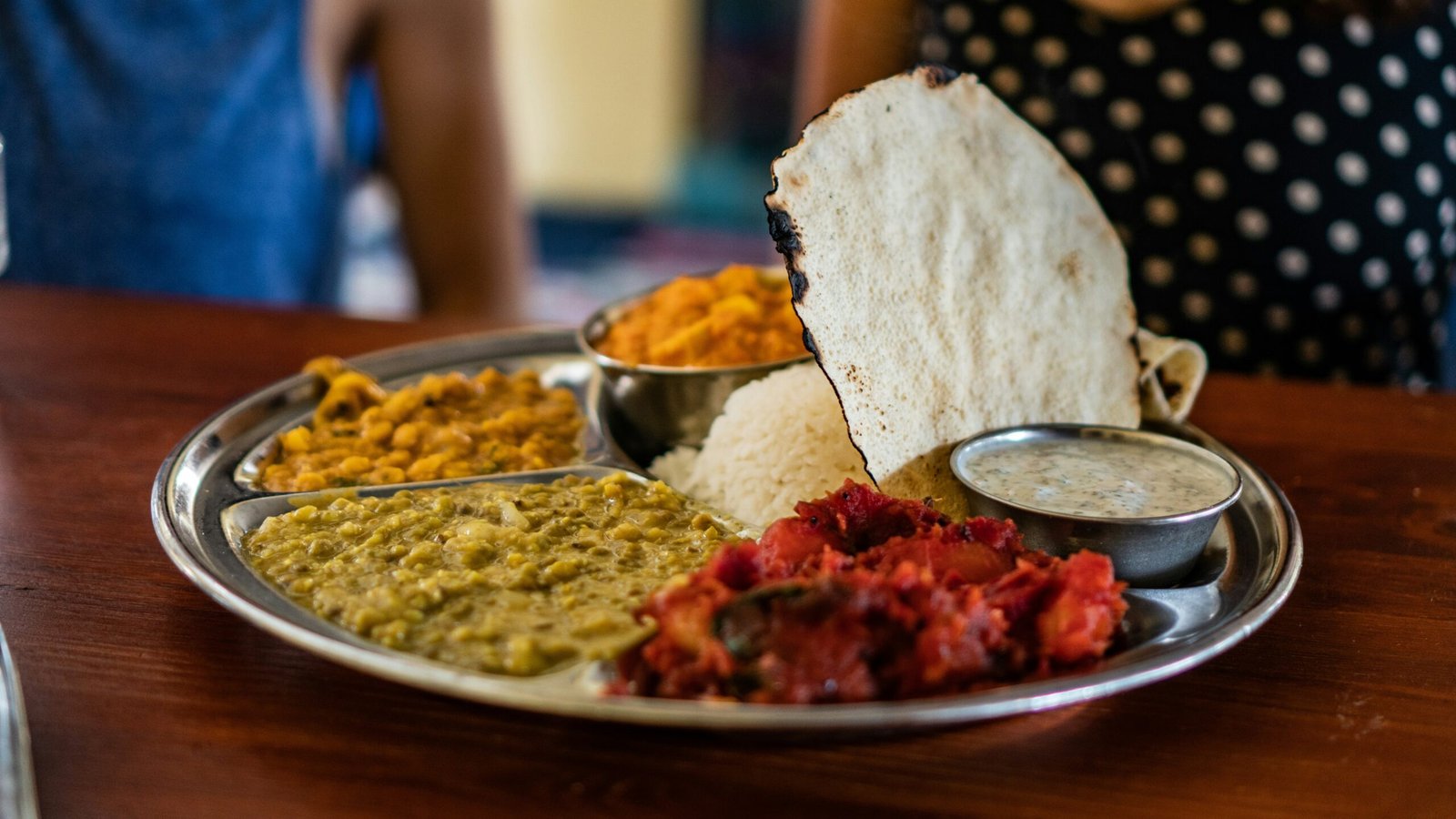 flatbread beside steam rice and stew meat platter